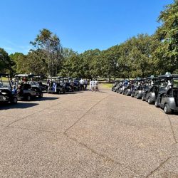 Golfers walking to golf carts