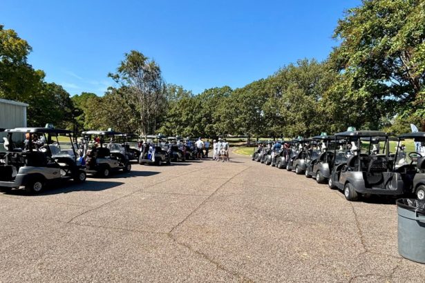 Golfers walking to golf carts