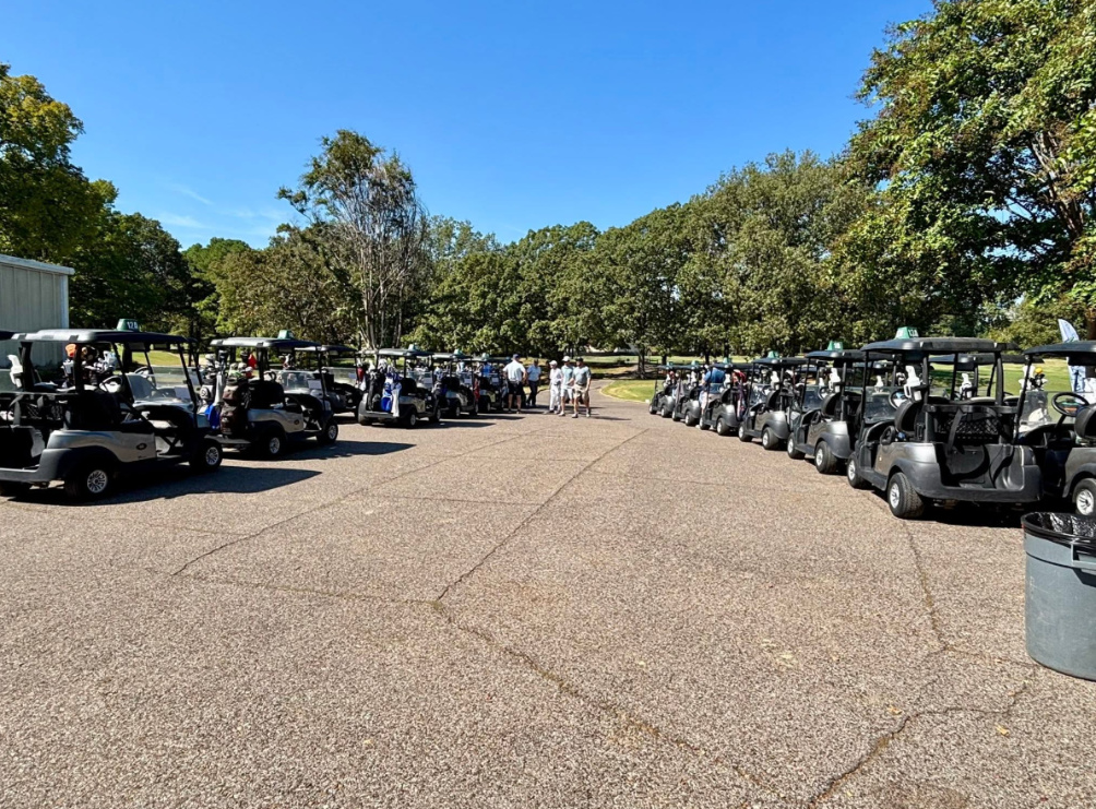 Golfers walking to golf carts