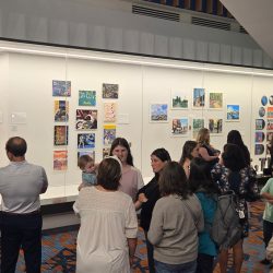 People looking at art on the wall