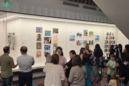 People looking at art on the wall