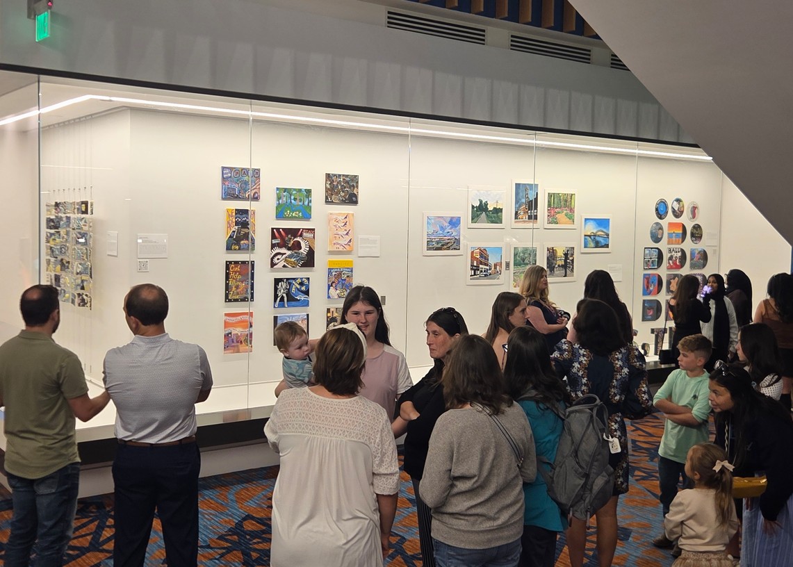 People looking at art on the wall