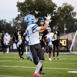 Conner looks into the sky as the football comes towards his hands.
