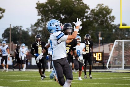 Conner looks into the sky as the football comes towards his hands.