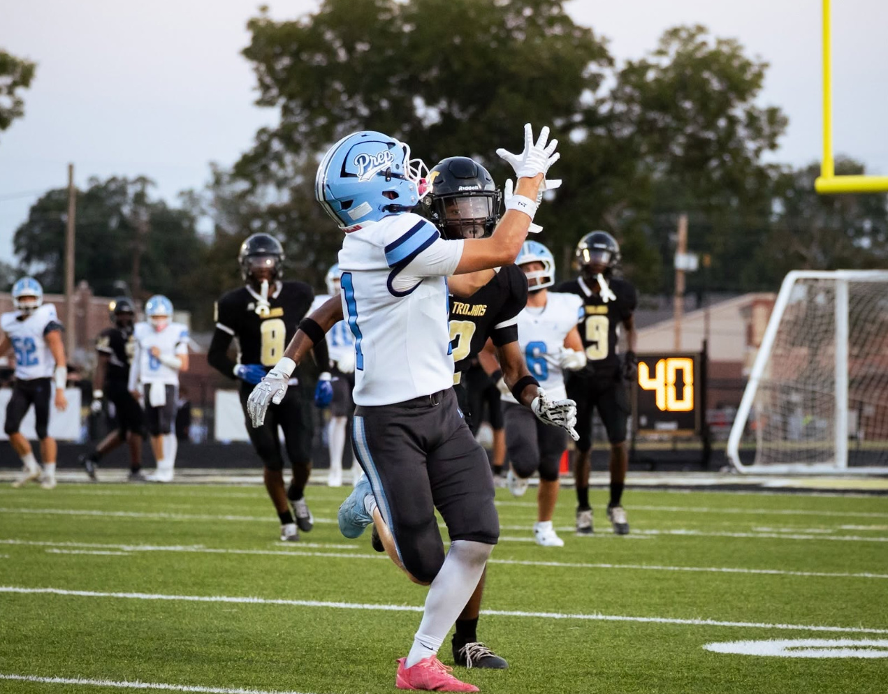 Conner looks into the sky as the football comes towards his hands.