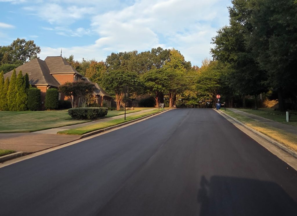 New pavenemt on street with stop sign.