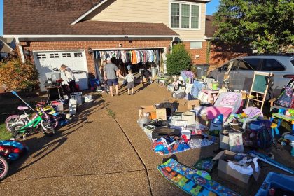 Man looking through items at a yard sale.
