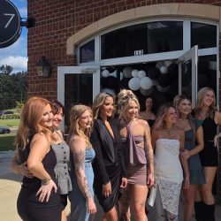 Women standing in front of 387 salon.