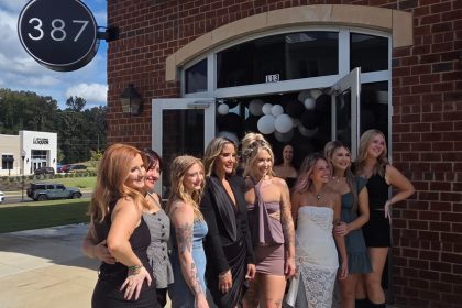 Women standing in front of 387 salon.