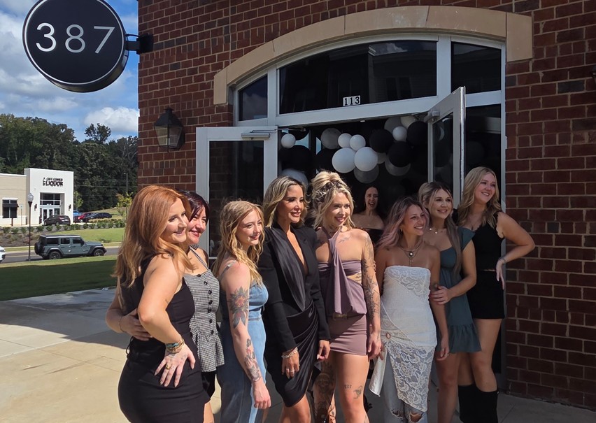 Women standing in front of 387 salon.